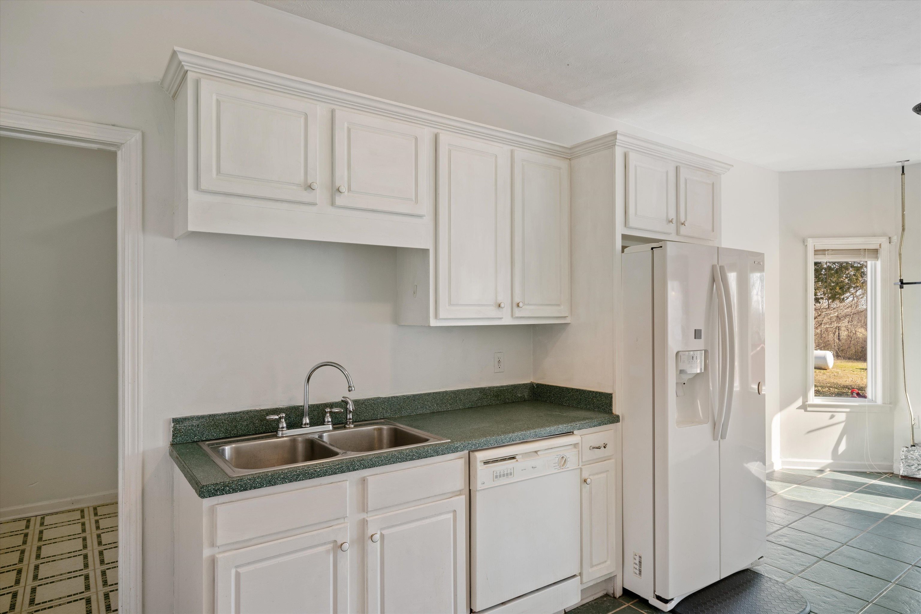 130 Belmont Road Mason, TN 38049 - Photo 9 of 24 Kitchen featuring sink, white appliances, white cabinets, and dark tile patterned flooring