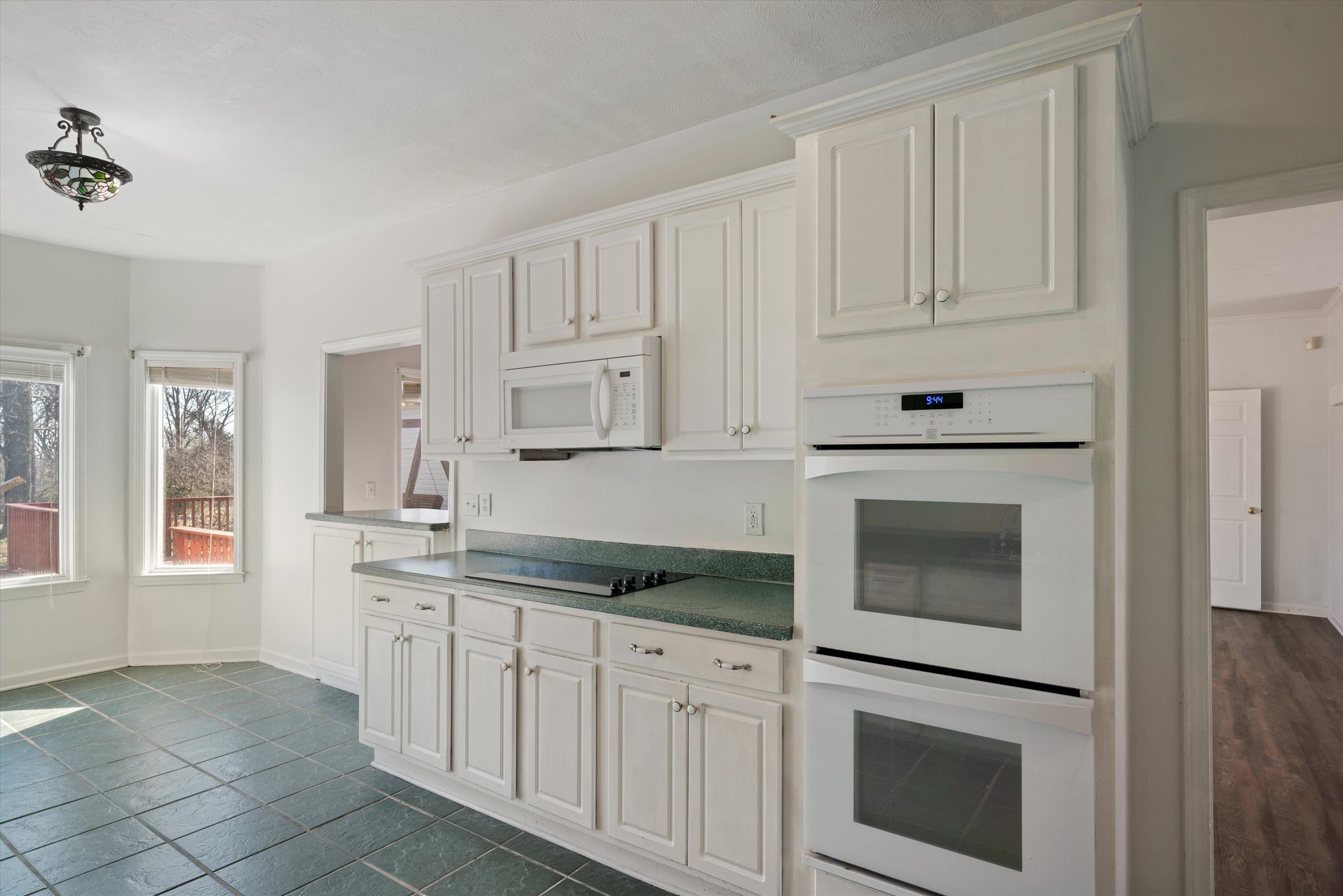 130 Belmont Road Mason, TN 38049 - Photo 10 of 24 Kitchen featuring white cabinetry, white appliances, and dark tile patterned floors