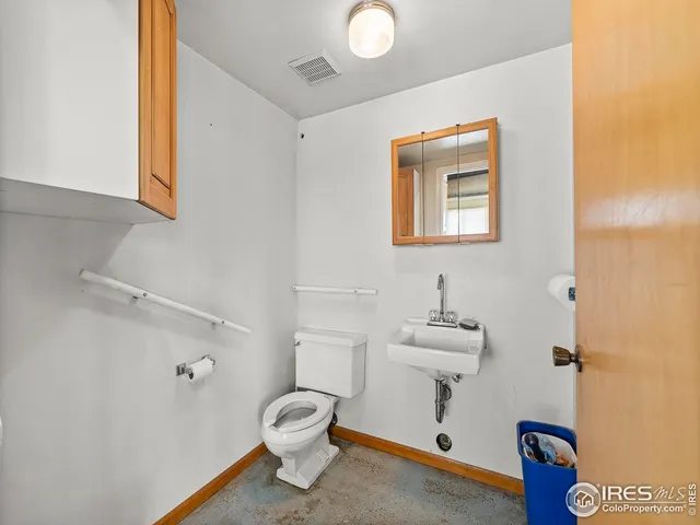 a bathroom with a sink mirror and toilet
