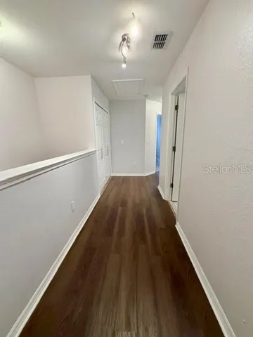 a view of hallway with wooden floor