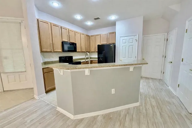 a view of a kitchen with electric appliances