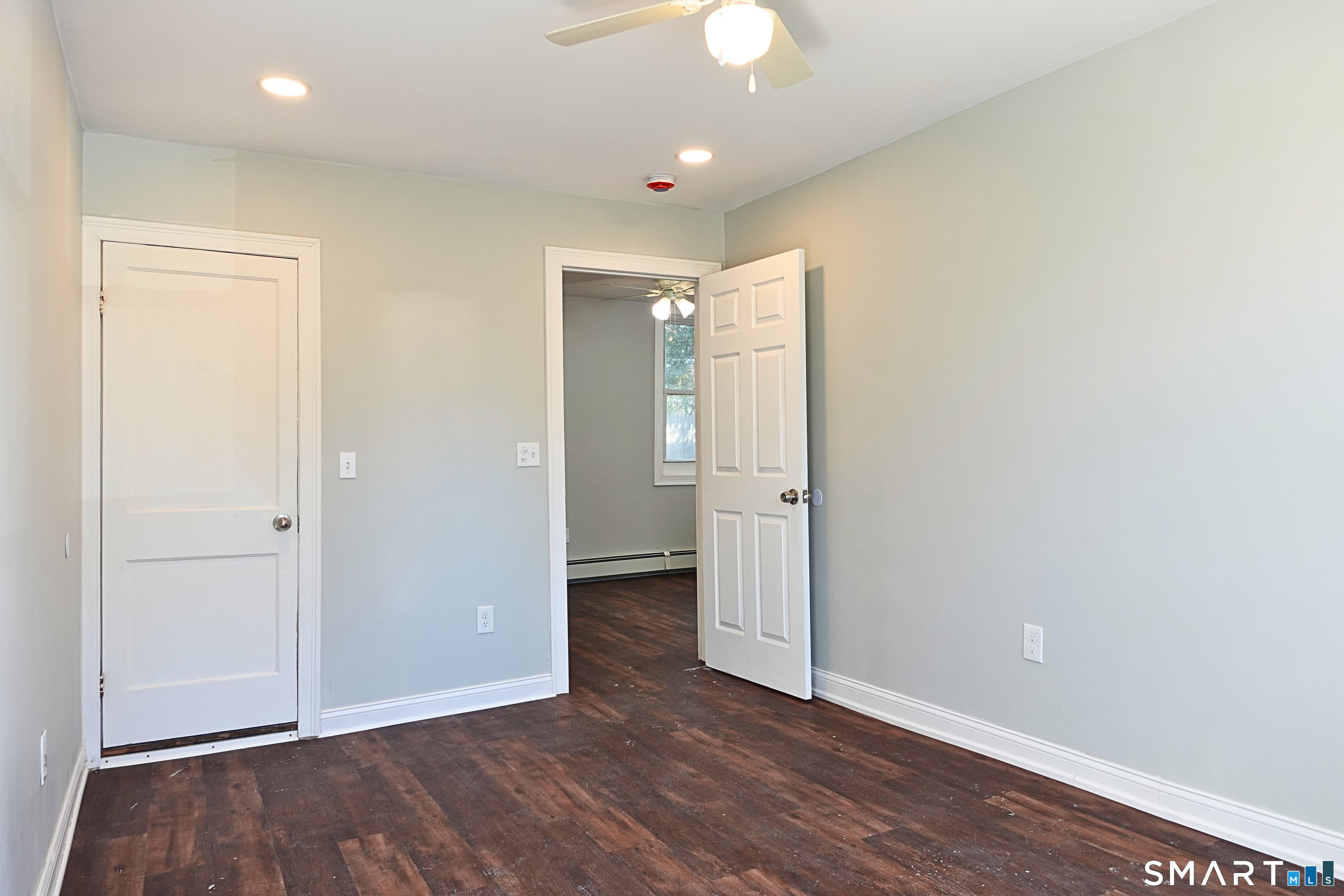 88 Taftville-Occum Road, Unit C Norwich, CT 06360 - Photo 13 of 28 an empty room with wooden floor and bathroom space