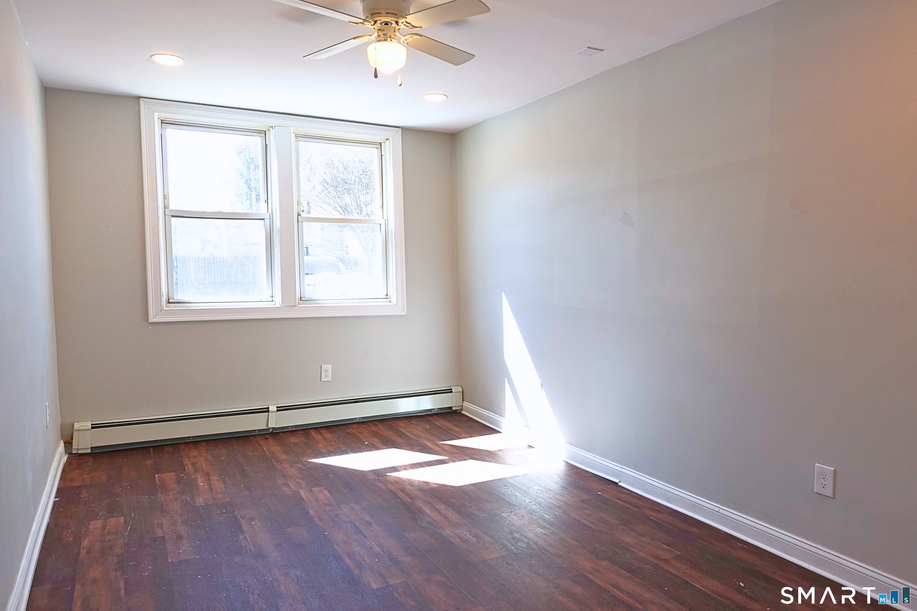 88 Taftville-Occum Road, Unit C Norwich, CT 06360 - Photo 14 of 28 an empty room with wooden floor and windows