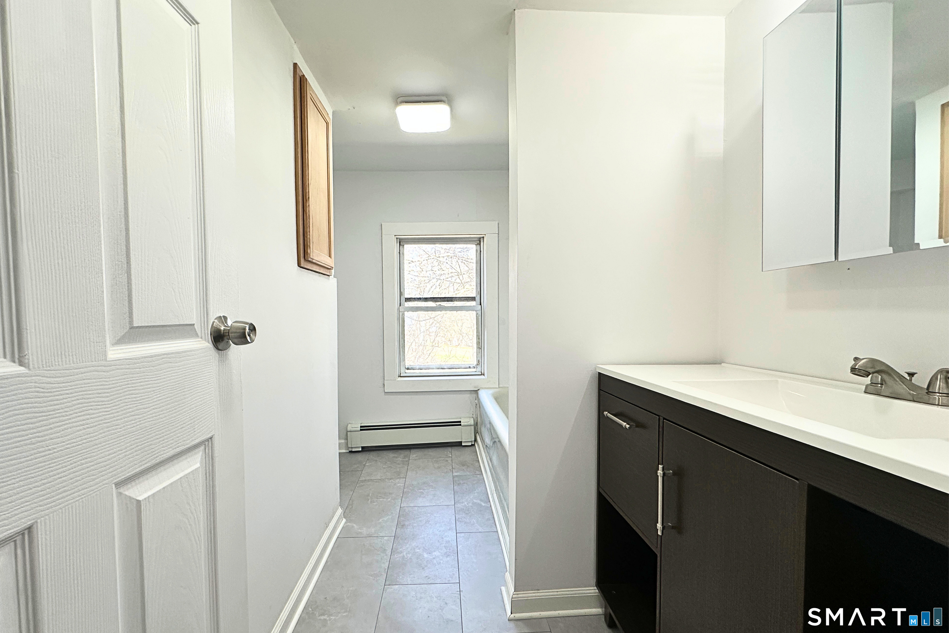 88 Taftville-Occum Road, Unit C Norwich, CT 06360 - Photo 17 of 28 a bathroom with a sink and a mirror