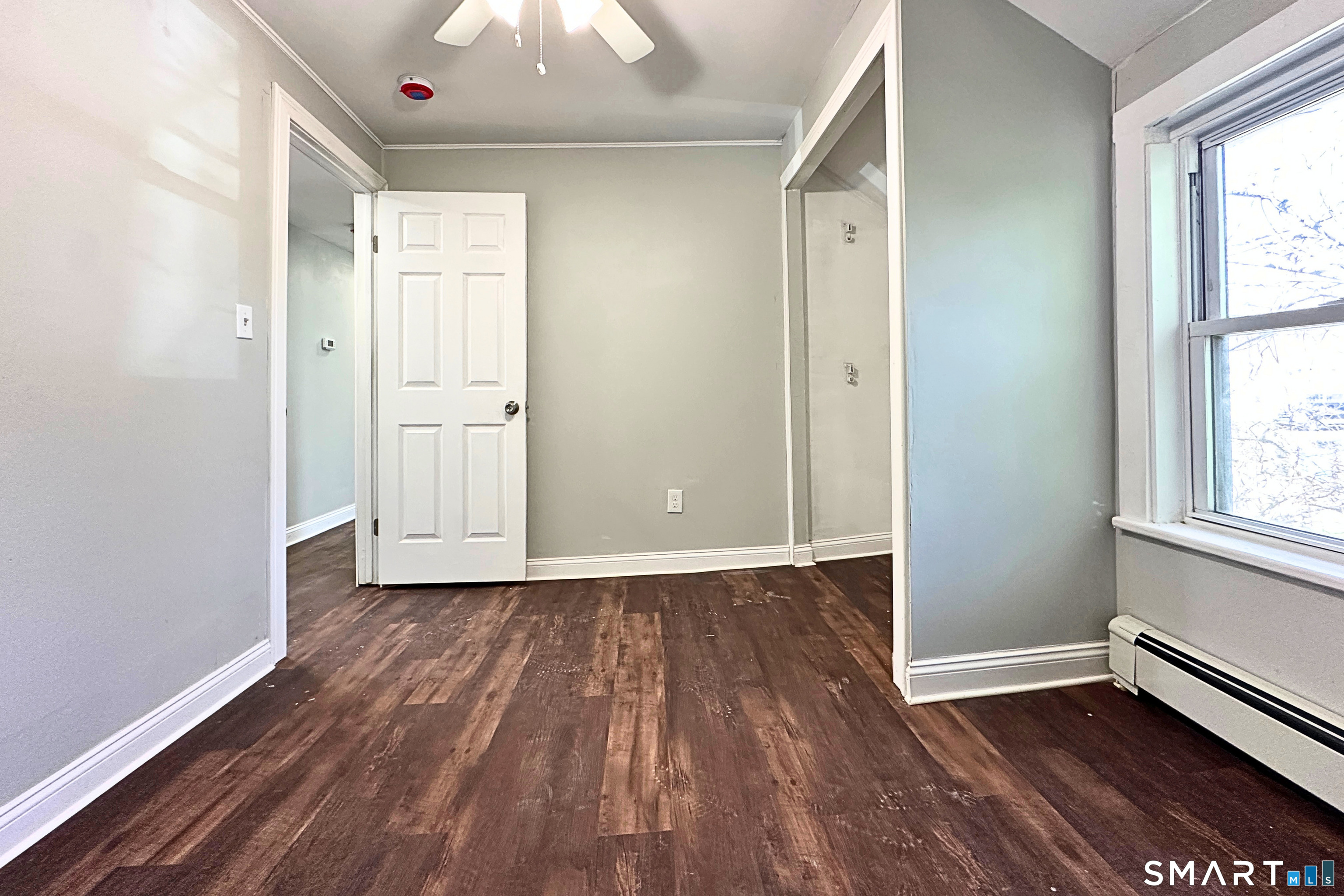 88 Taftville-Occum Road, Unit C Norwich, CT 06360 - Photo 20 of 28 an empty room with wooden floor and windows