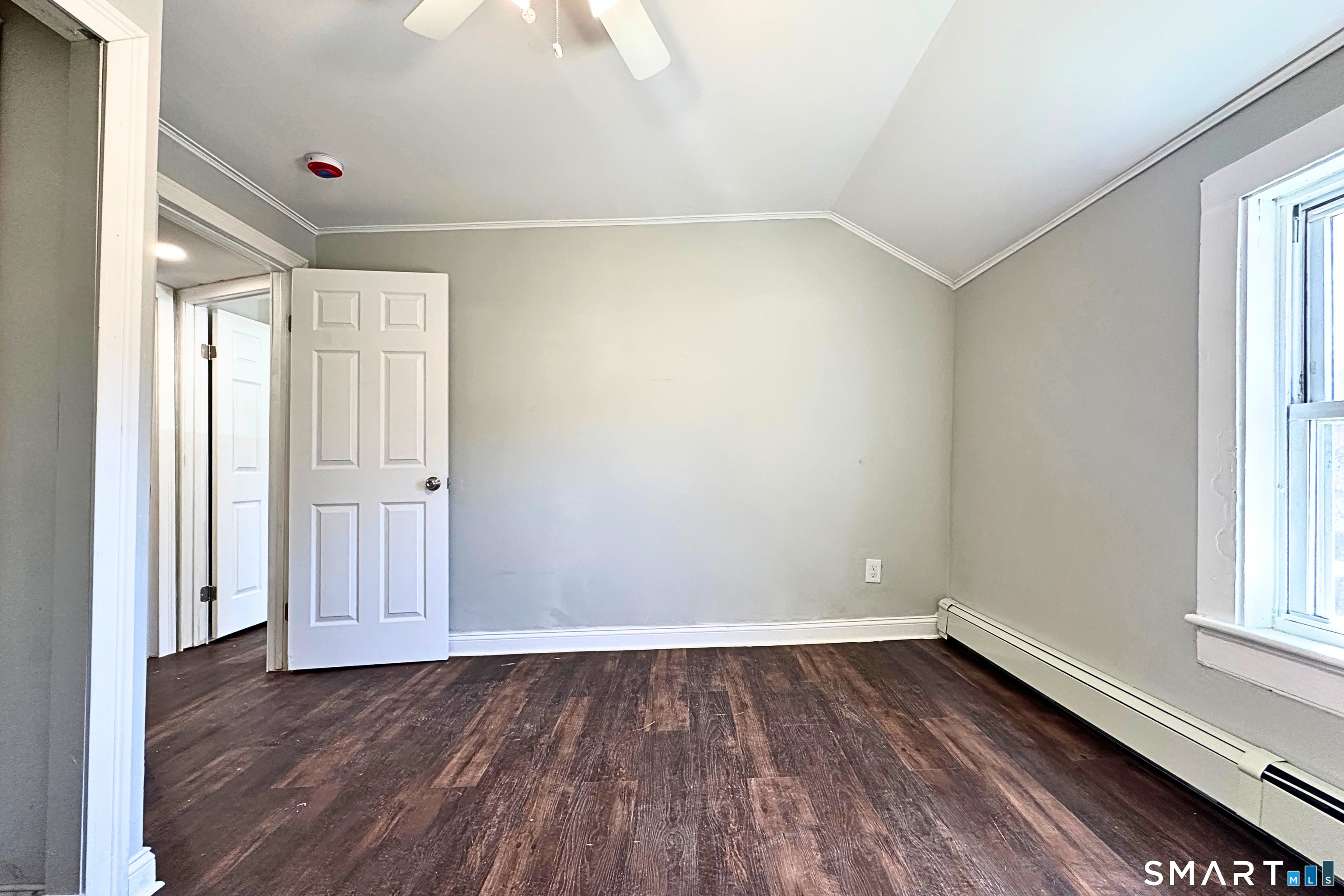 88 Taftville-Occum Road, Unit C Norwich, CT 06360 - Photo 24 of 28 a view of an empty room with wooden floor and a window