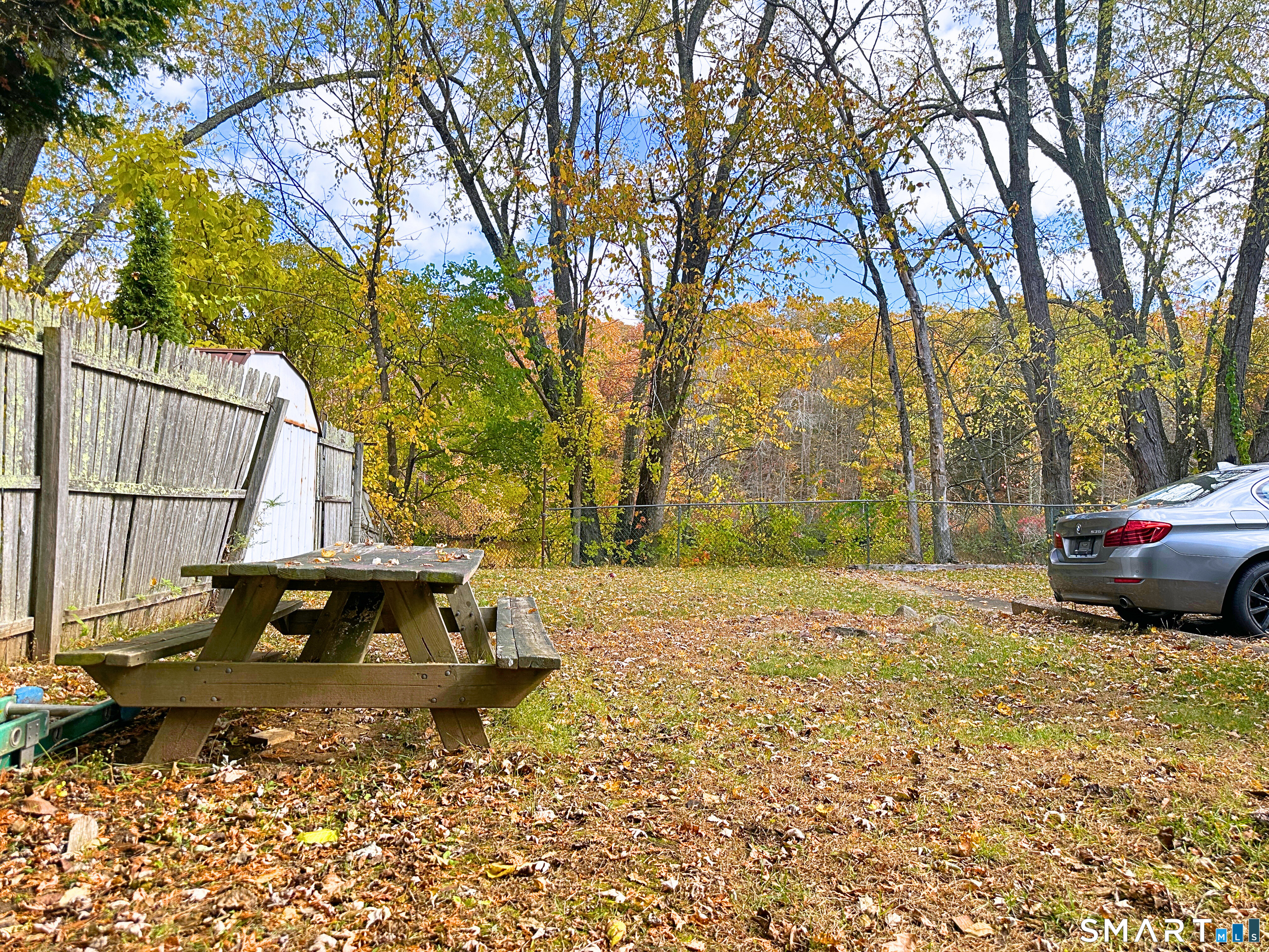 88 Taftville-Occum Road, Unit C Norwich, CT 06360 - Photo 28 of 28 a view of a yard with a house and trees