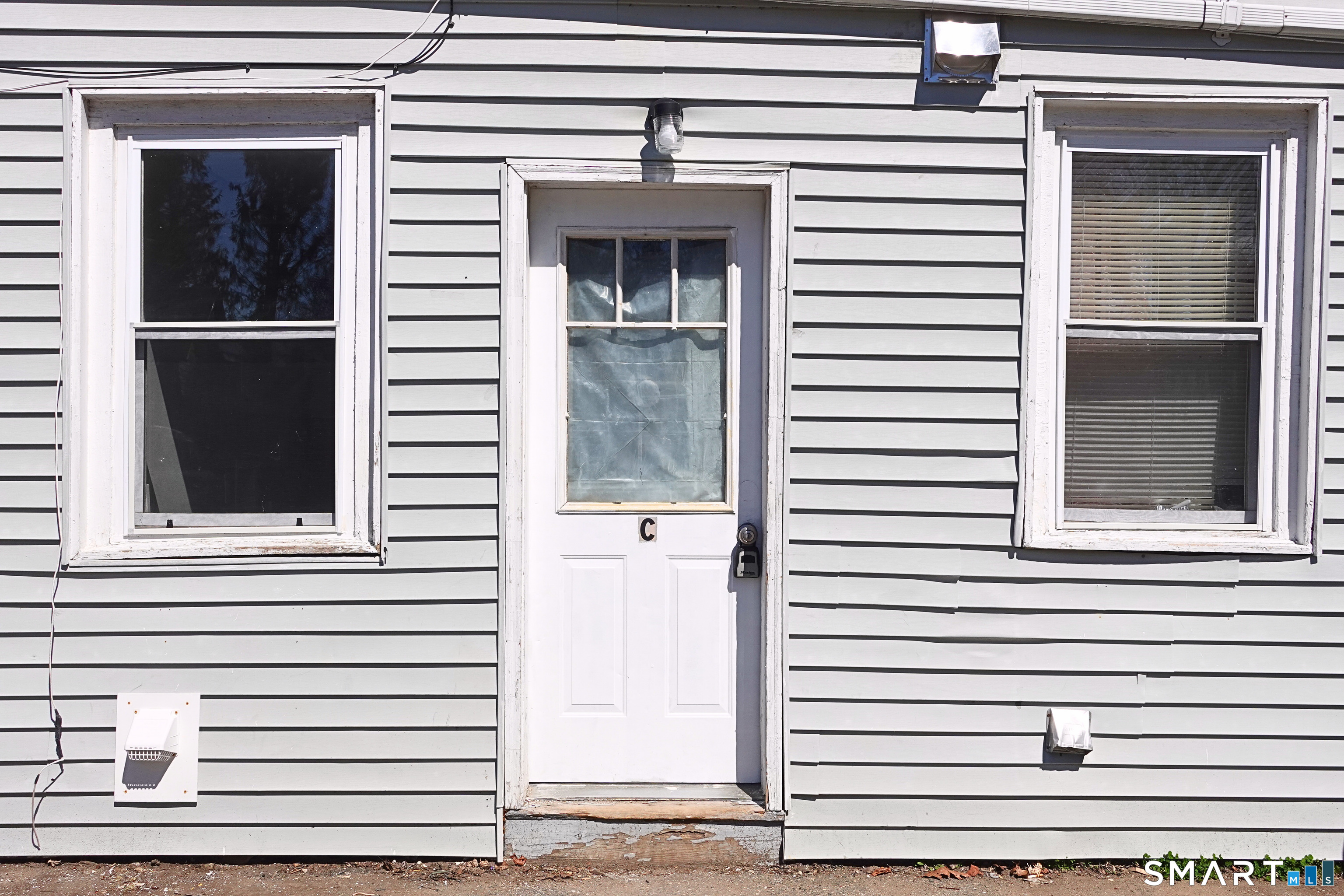 88 Taftville-Occum Road, Unit C Norwich, CT 06360 - Photo 5 of 28 a view of a house with a door and a window