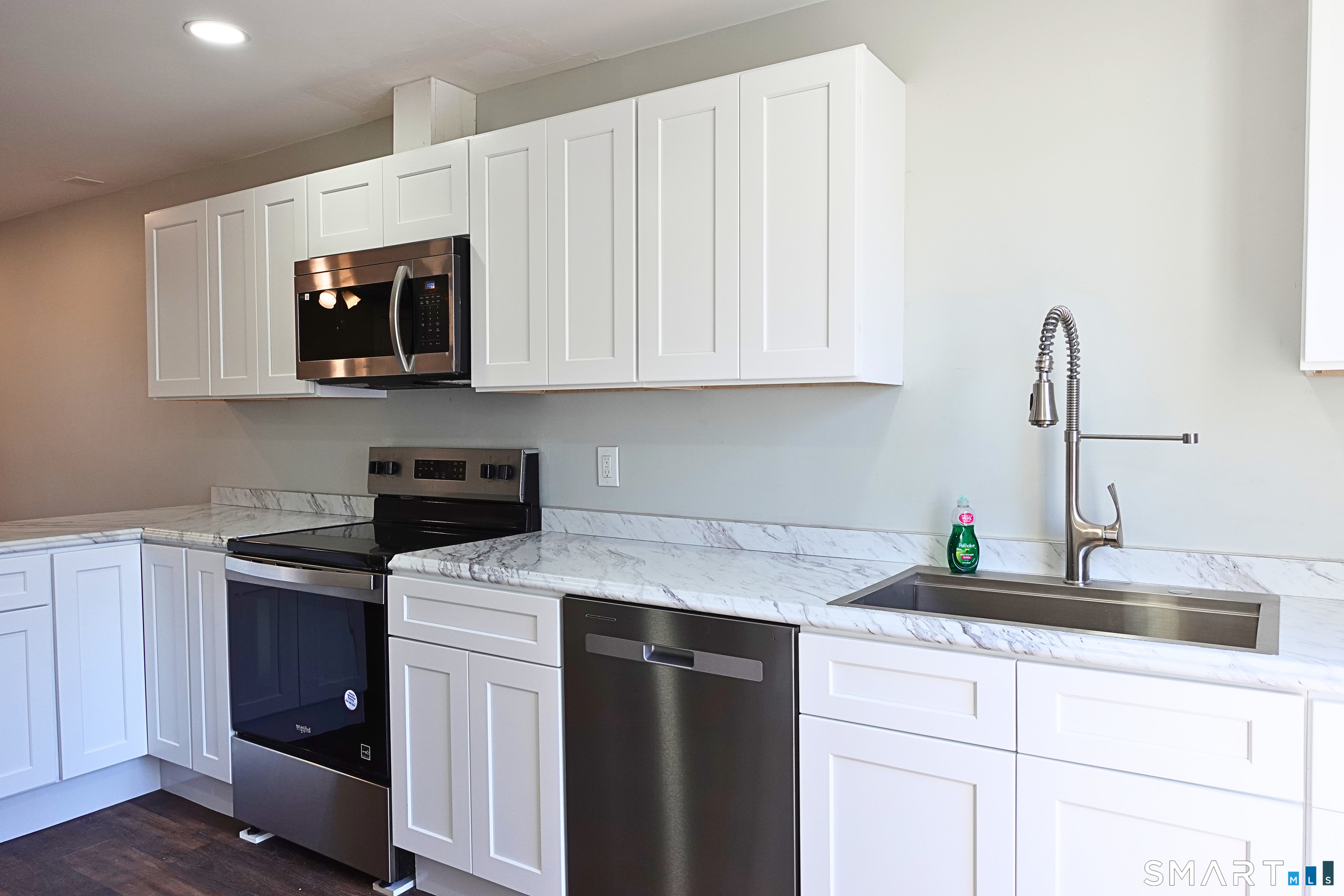 88 Taftville-Occum Road, Unit C Norwich, CT 06360 - Photo 9 of 28 a kitchen with white cabinets and sink