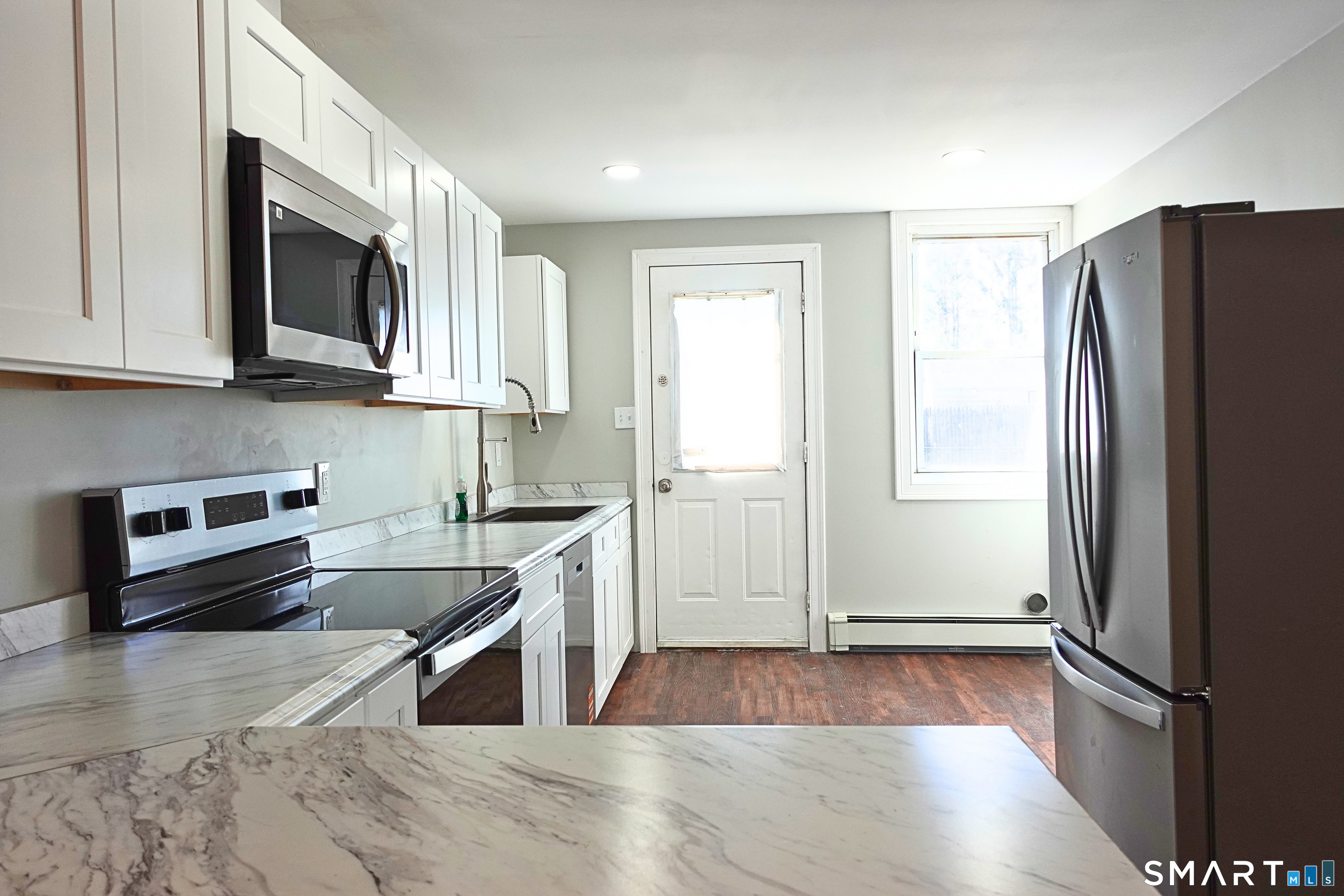 88 Taftville-Occum Road, Unit C Norwich, CT 06360 - Photo 10 of 28 a kitchen with stainless steel appliances granite countertop a refrigerator stove and sink