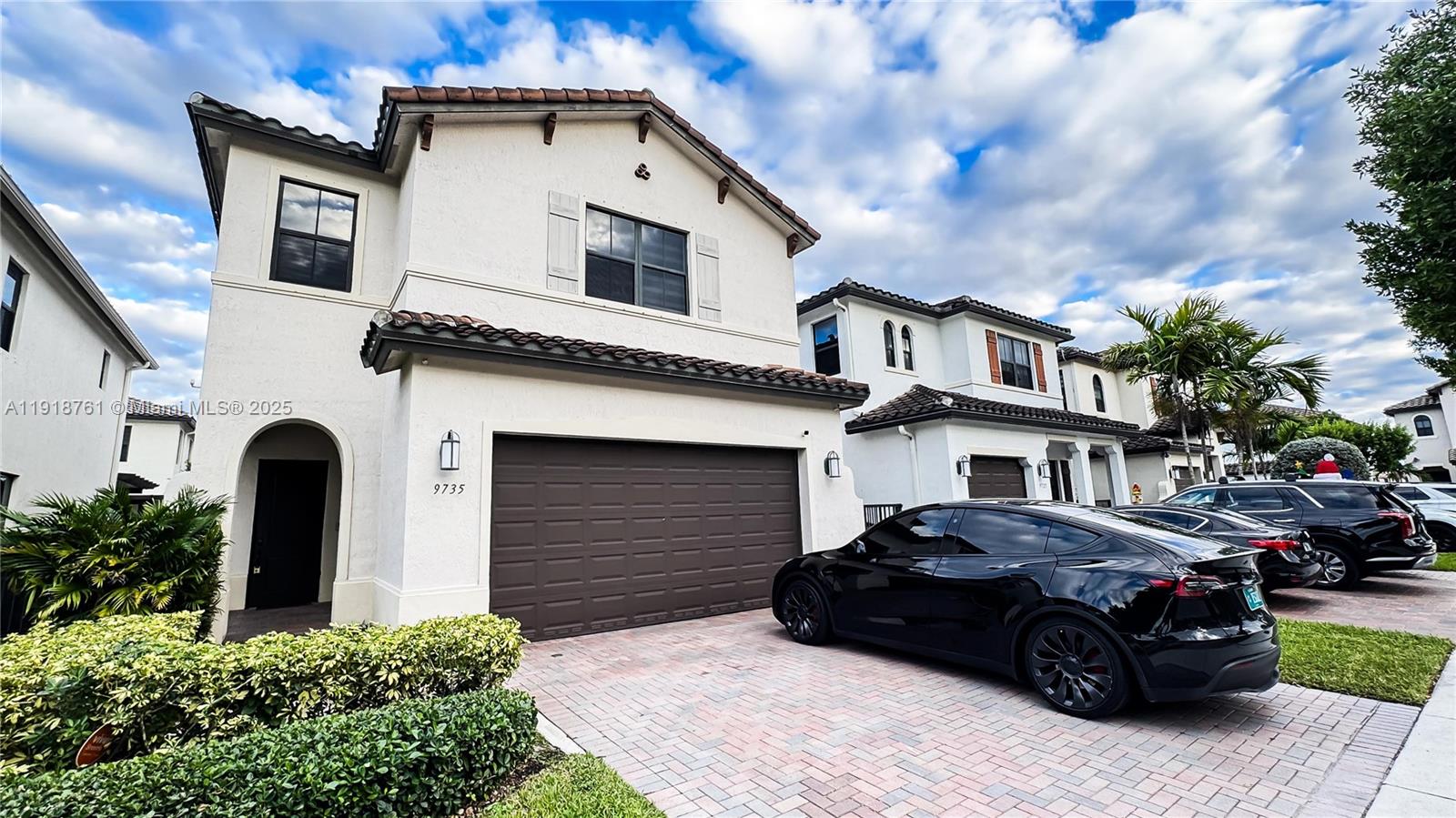 a car parked in front of a white building