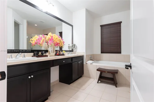 a bathroom with a sink vanity and a mirror
