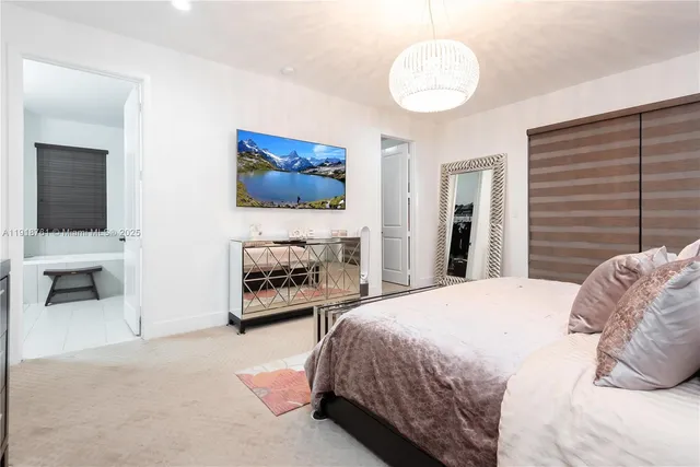 a bedroom with a bed and a television