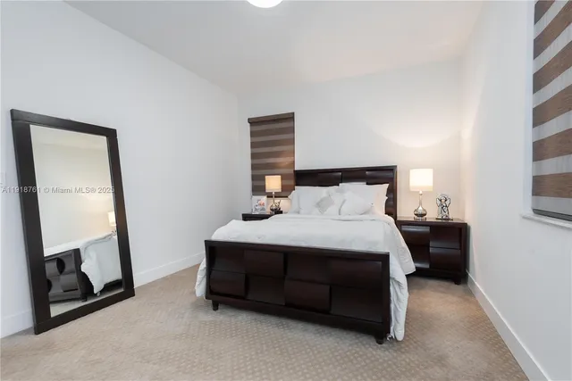 a bedroom with a bed and a mirror