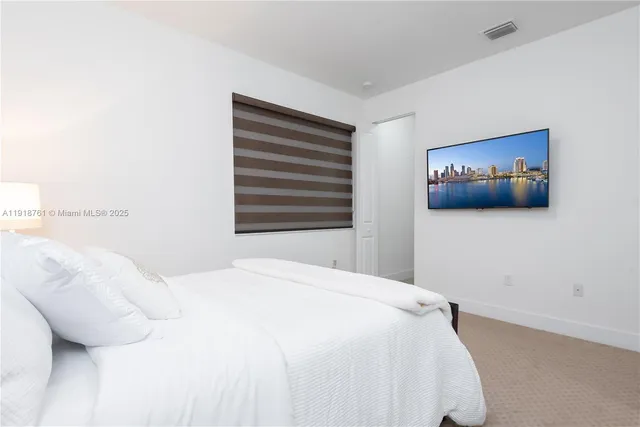 a bedroom with a bed and a wall painting