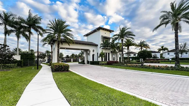 a front view of a house with fountain and garden