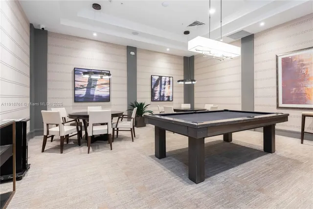 a room with furniture pool table table tennis table and a window