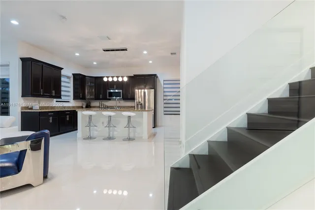 a view of kitchen with microwave and cabinets