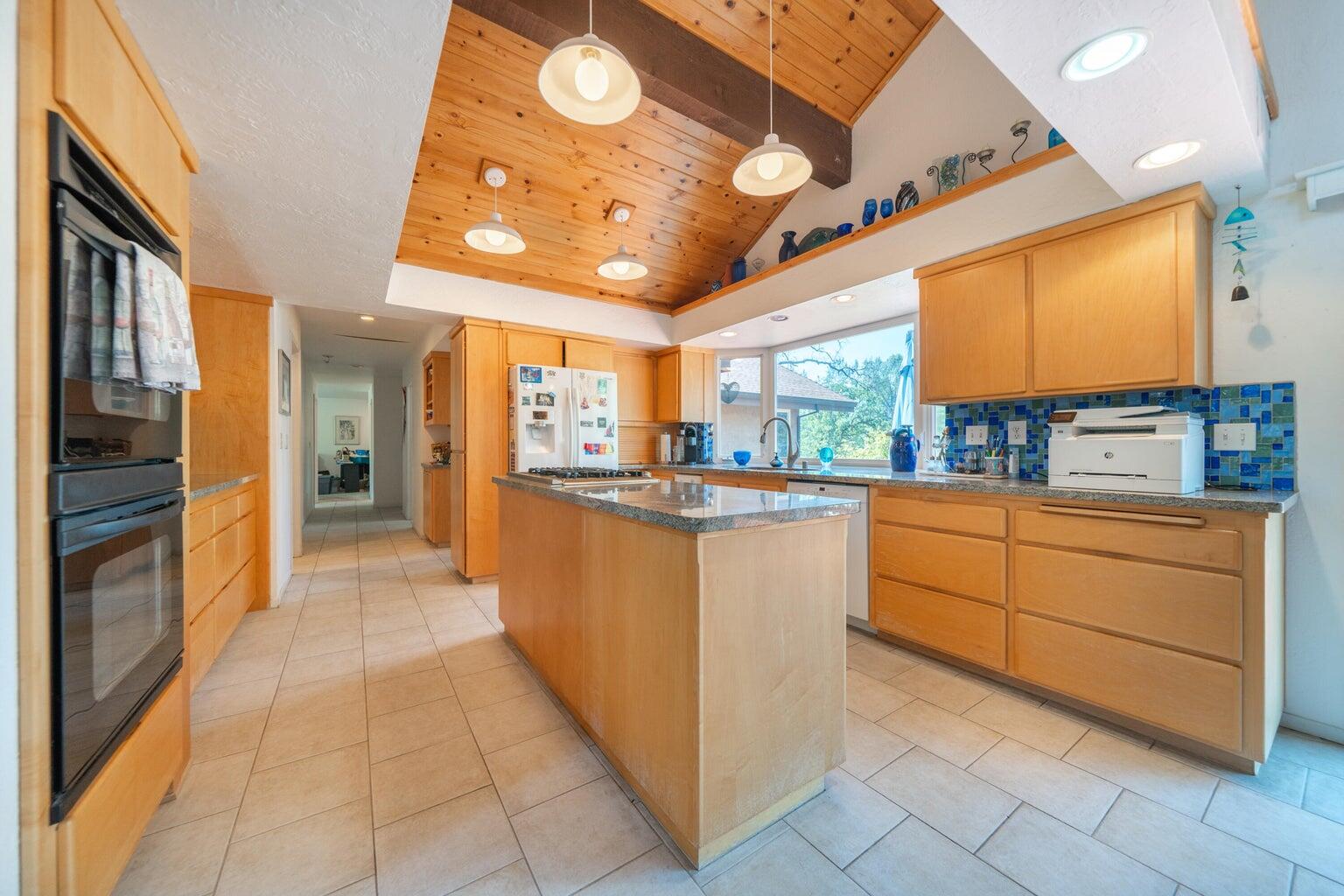 8846 Goldstone Lane Redding, CA 96001 - Photo 18 of 64 a kitchen with cabinets and wooden floor