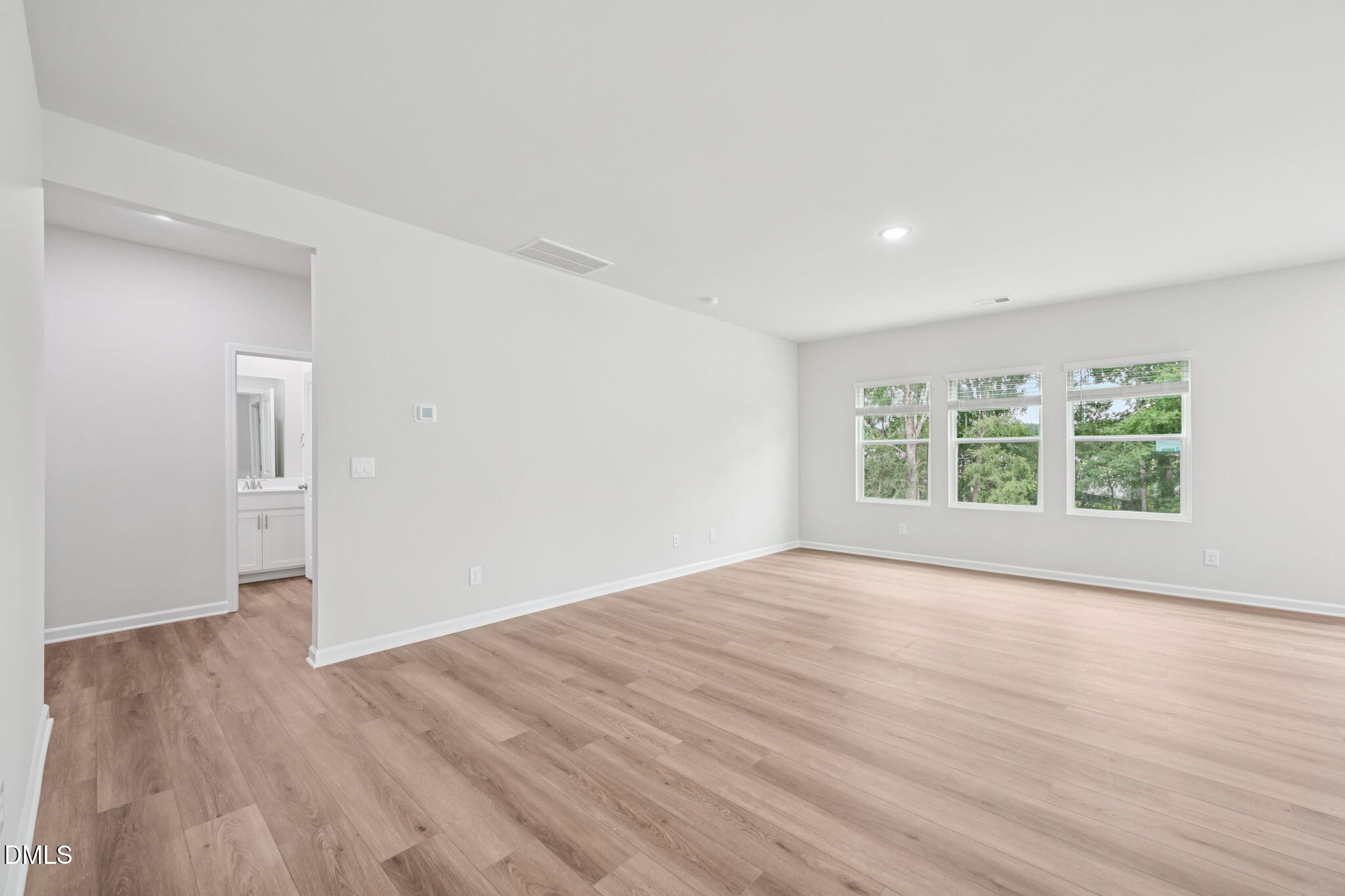 1454 Hatteras Road Durham, NC 27703 - Photo 13 of 53 a view of an empty room with wooden floor and a window