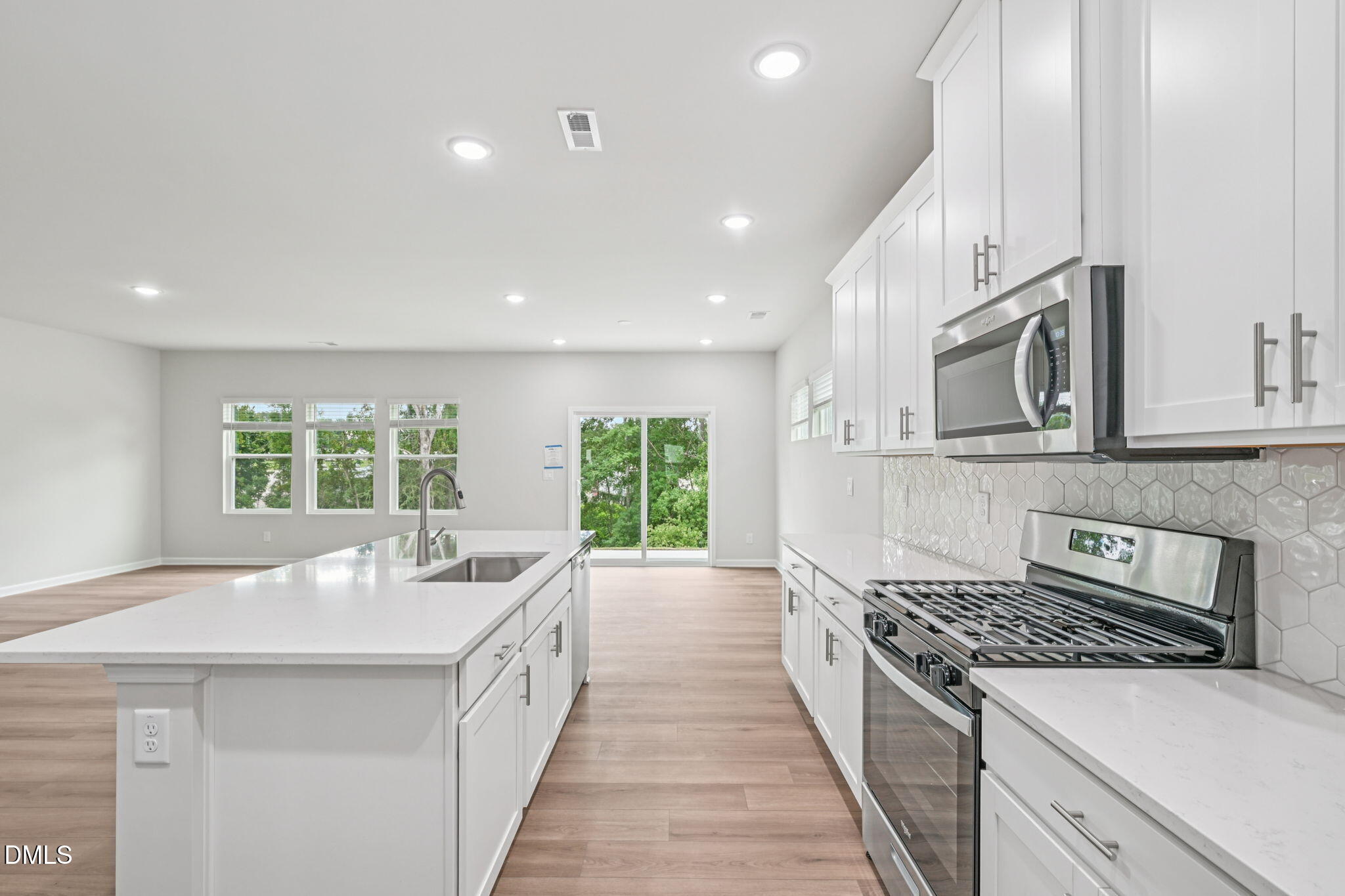 1454 Hatteras Road Durham, NC 27703 - Photo 18 of 53 a large white kitchen with a large window