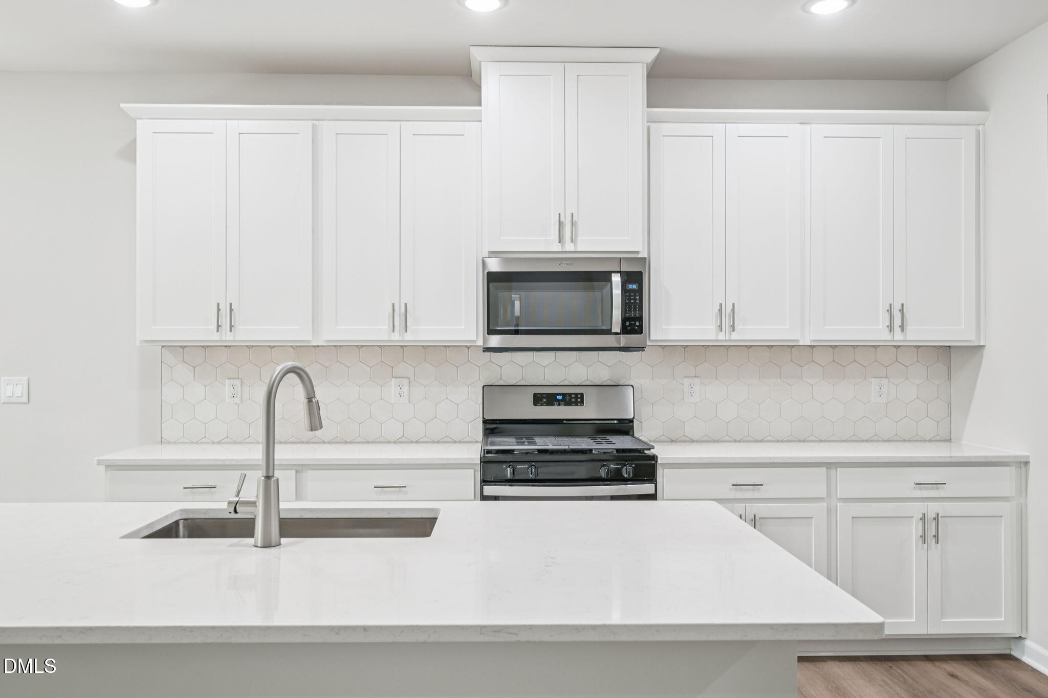 1454 Hatteras Road Durham, NC 27703 - Photo 20 of 53 a kitchen with granite countertop white cabinets and stainless steel appliances