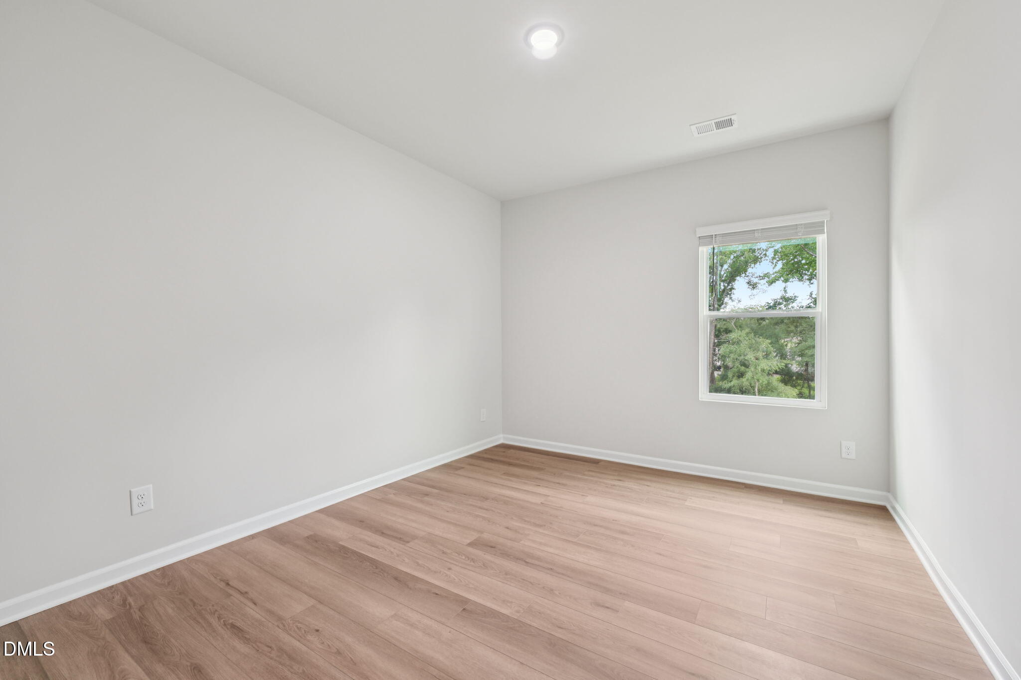 1454 Hatteras Road Durham, NC 27703 - Photo 27 of 53 an empty room with wooden floor and window