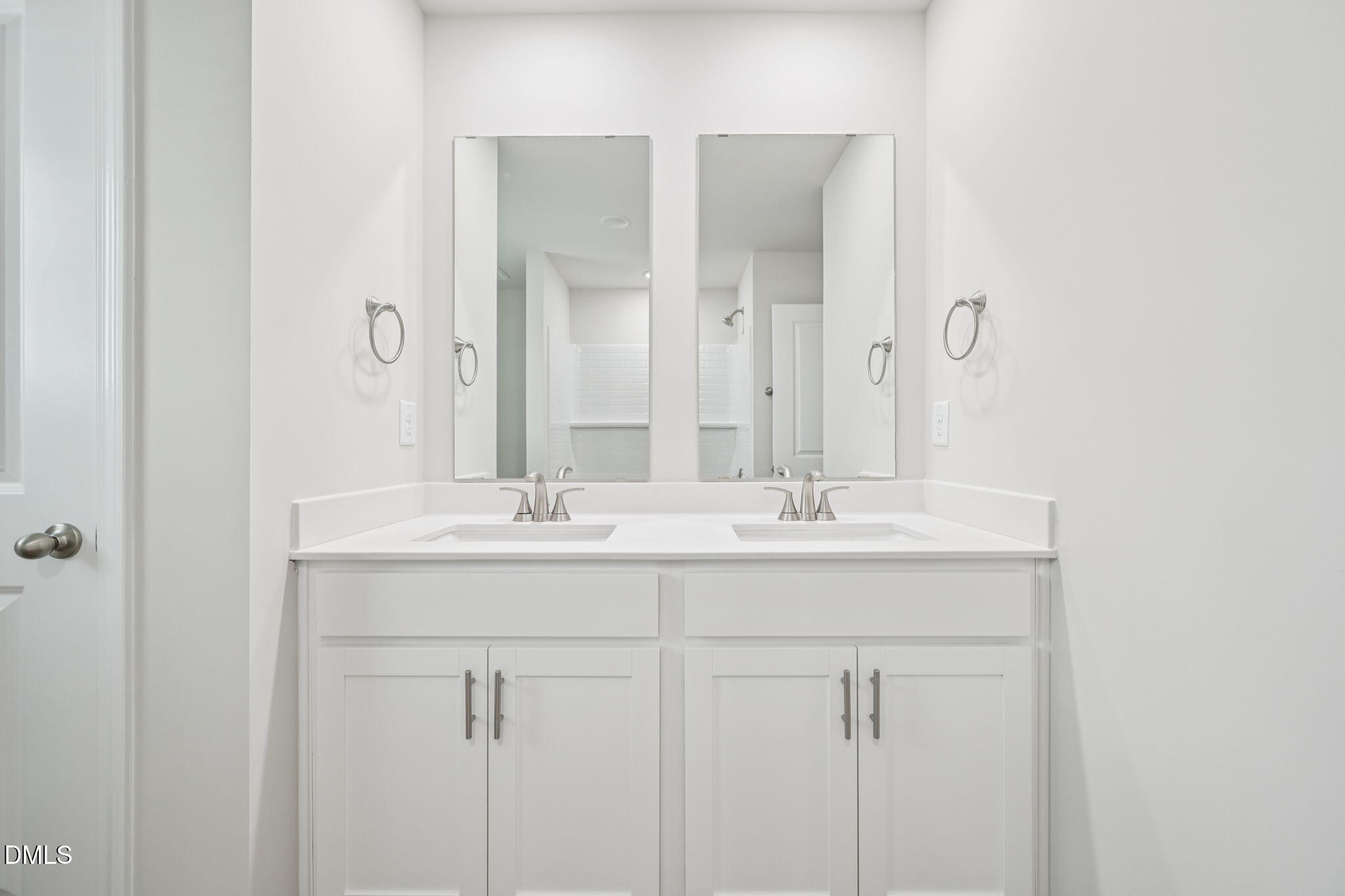 1454 Hatteras Road Durham, NC 27703 - Photo 47 of 53 a bathroom with double sink and a mirror
