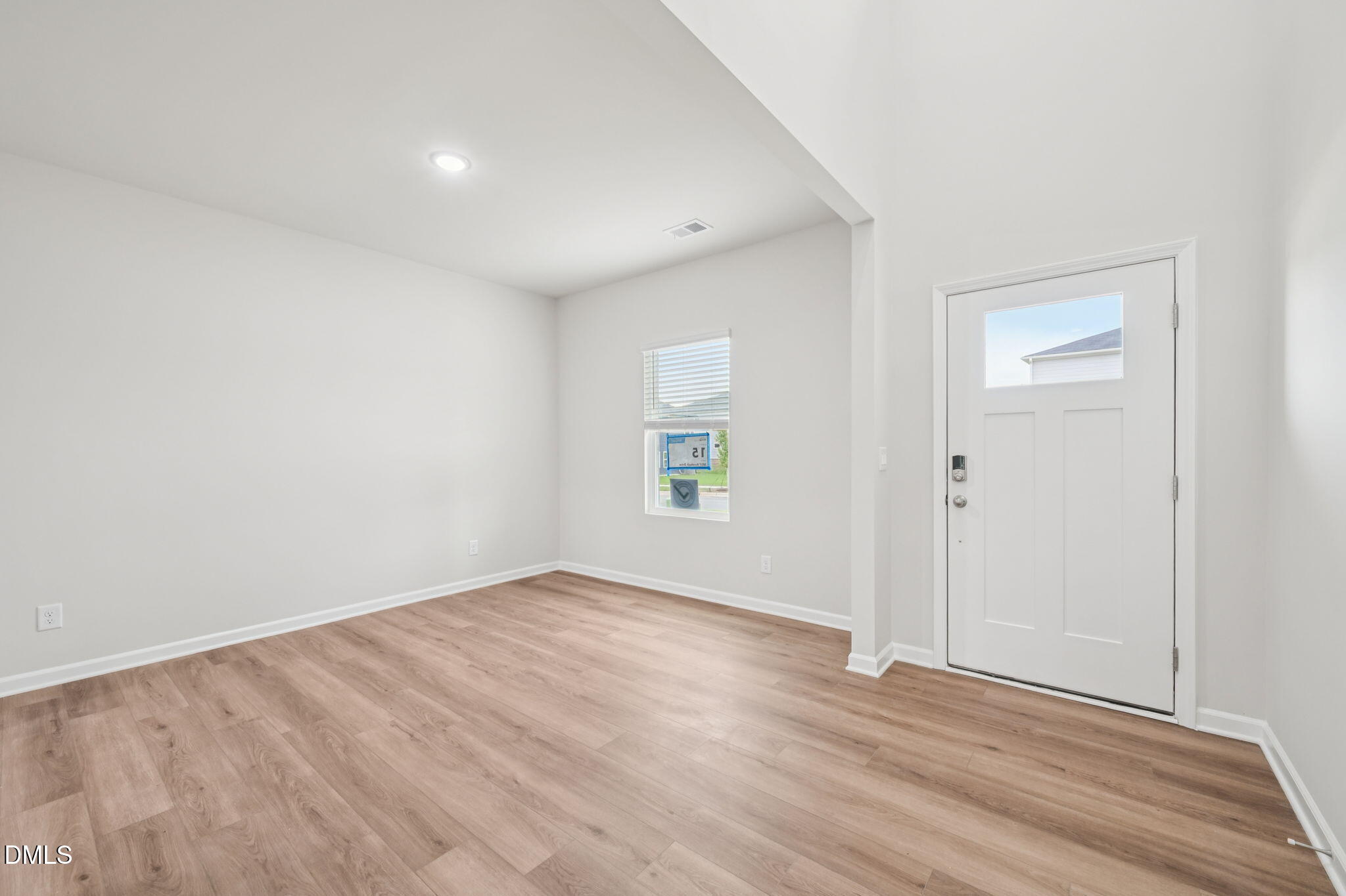 1454 Hatteras Road Durham, NC 27703 - Photo 5 of 53 a view of an empty room with wooden floor and a window