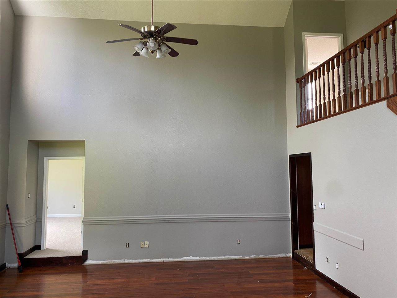 305 Adkins Cemetery Road Newbern, TN 38059 - Photo 8 of 23 a view of an empty room with wooden floor and a ceiling fan