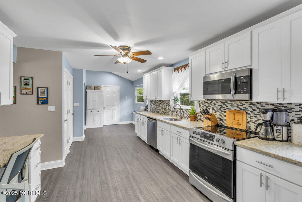 375 South Stump Tavern Road Jackson, NJ 08527 - Photo 11 of 34 a large kitchen with cabinets wooden floor and stainless steel appliances