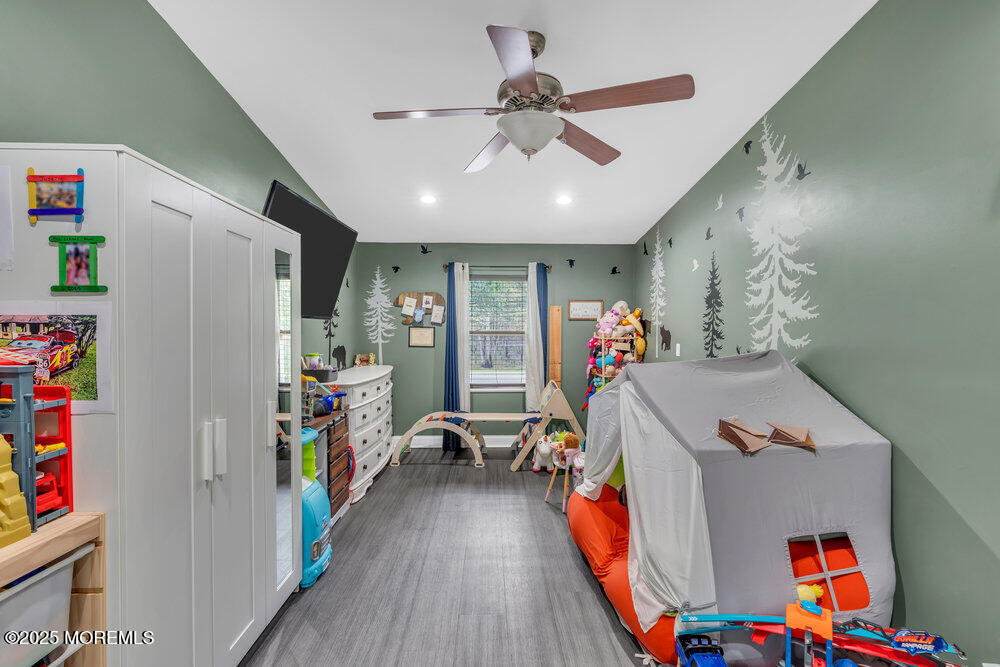 375 South Stump Tavern Road Jackson, NJ 08527 - Photo 15 of 34 a bed room with a bed and a chandelier