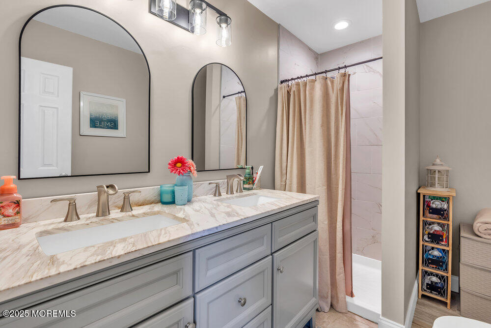 375 South Stump Tavern Road Jackson, NJ 08527 - Photo 22 of 34 a bathroom with a double vanity sink and a mirror