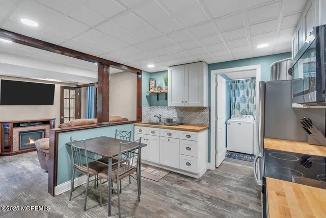 a kitchen with granite countertop a table chairs sink and cabinets