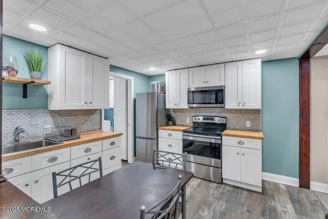 a kitchen with stainless steel appliances a stove sink microwave and cabinets