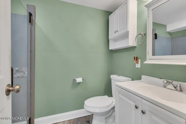 a bathroom with a sink a toilet and mirror