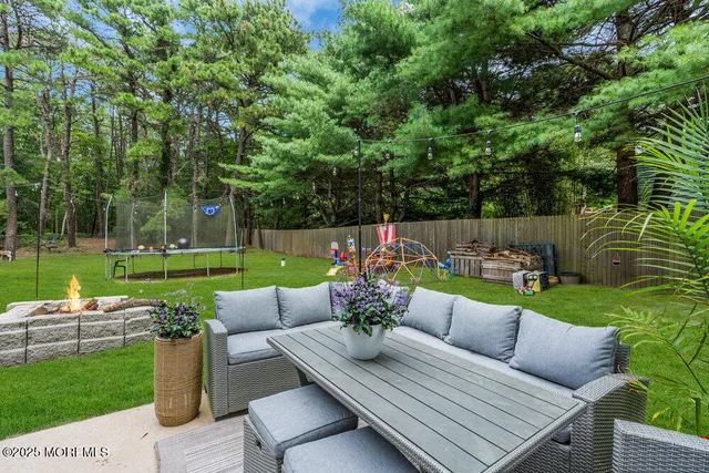 a view of a patio with couches chairs and a yard
