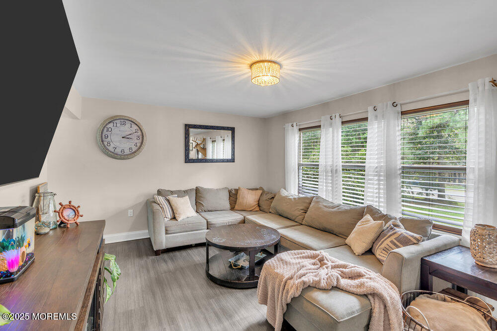 375 South Stump Tavern Road Jackson, NJ 08527 - Photo 4 of 34 a living room with furniture a clock and a large window