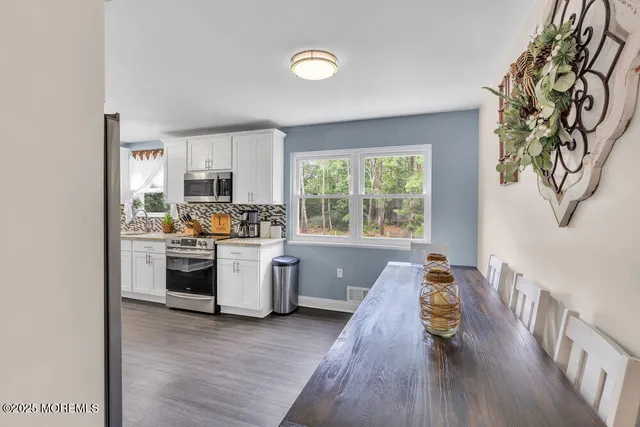 a kitchen with a refrigerator and a stove top oven