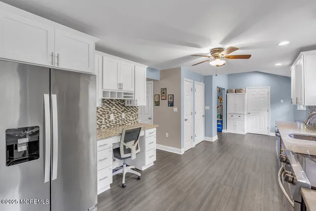 a view of a kitchen with furniture and a ceiling fan