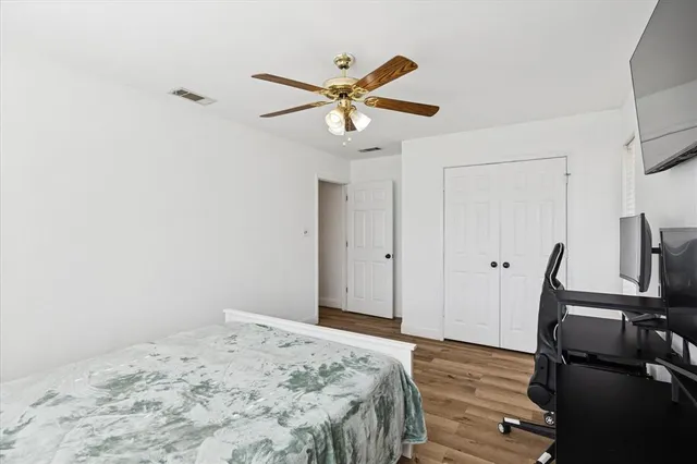 a bathroom with a granite countertop sink a toilet and shower