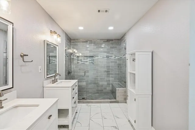 a spacious bathroom with a double vanity sink mirror and