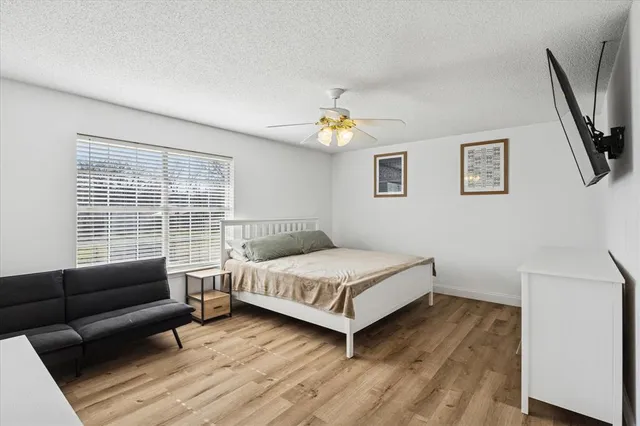 a bedroom with a bed and flat screen tv