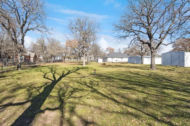 a view of road with large trees