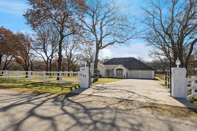a view of a yard with a house and large trees