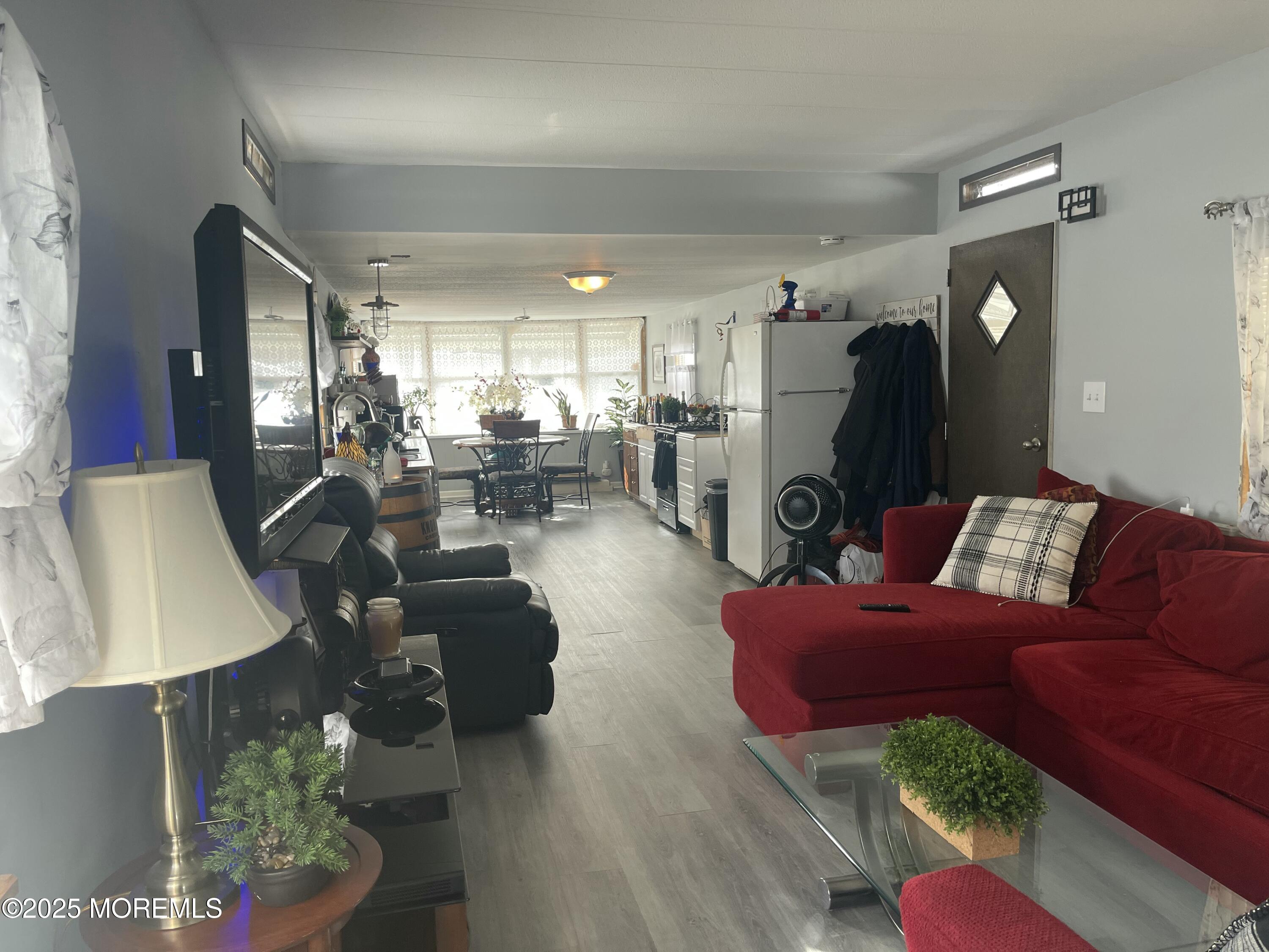 54 Alissa Terrace Jackson, NJ 08527 - Photo 2 of 13 a living room with furniture potted plant and a window