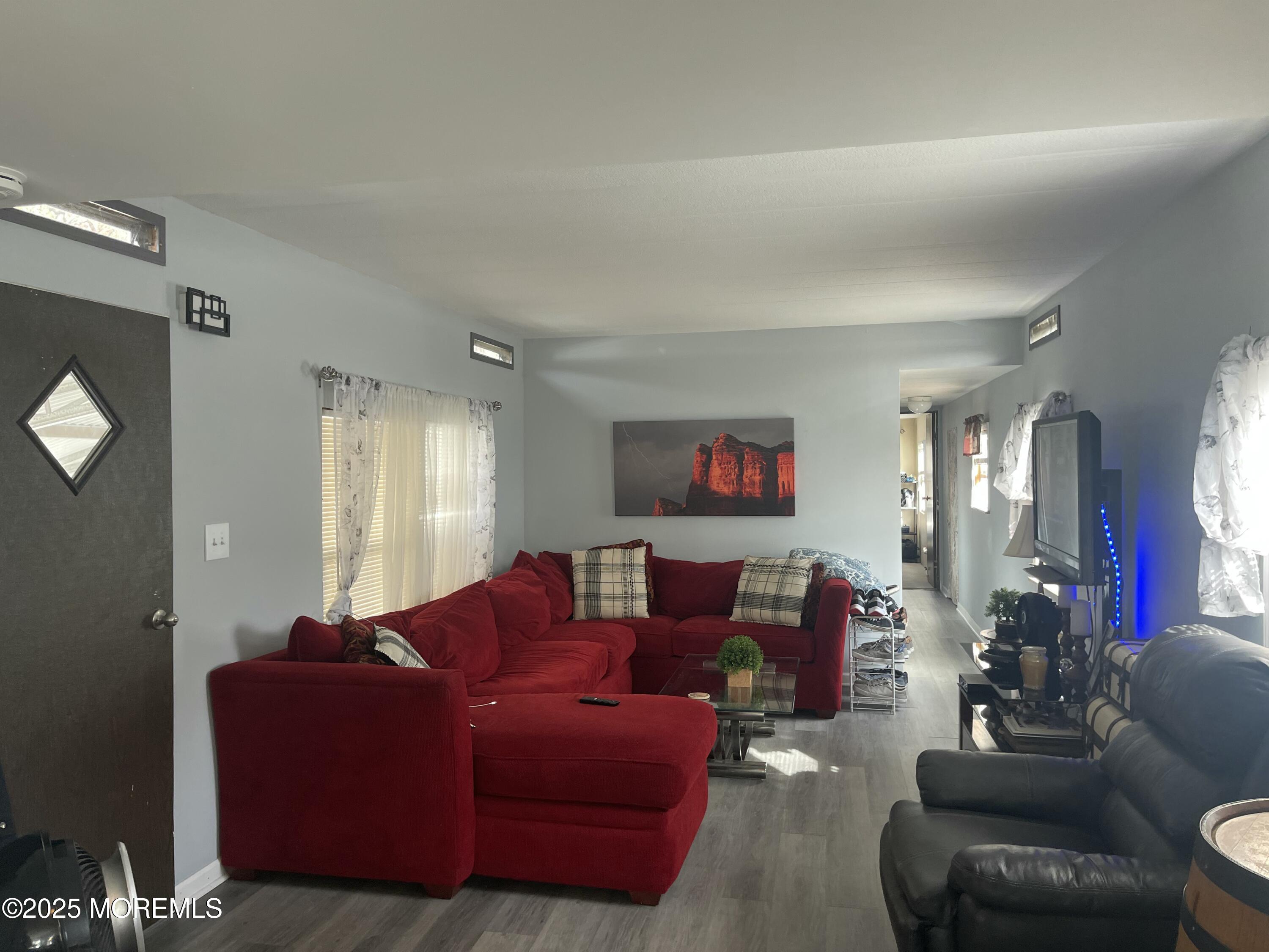 54 Alissa Terrace Jackson, NJ 08527 - Photo 3 of 13 a living room with furniture and a flat screen tv