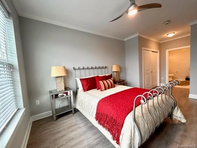 a bedroom with bed and a large window