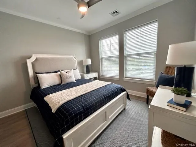 a bed room with a bed tv and a window