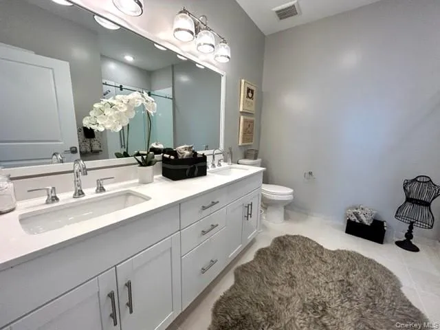 a bathroom with a double vanity sink and a mirror